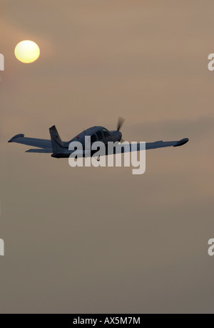 Piper aircraft flying in the evening sun over the ocean (composite shot), Egelsbach, Hesse, Germany, Europe Stock Photo