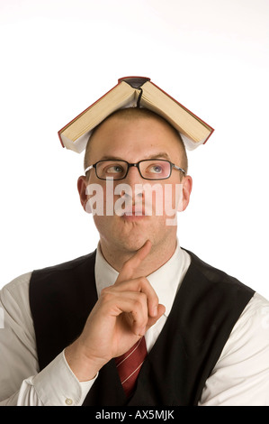 Young man balancing a book on his head Stock Photo