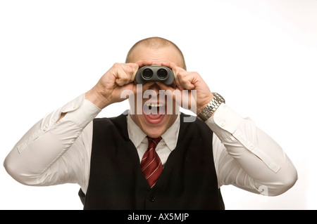Young man looking through binoculars Stock Photo