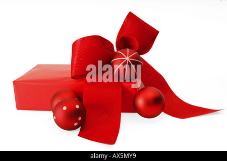 Red Christmas present with baubles and bow Stock Photo