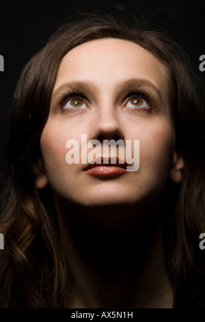 Portrait of a young woman, looking upward Stock Photo