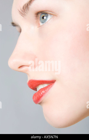 Close-up of young woman's face, profile, red lips Stock Photo