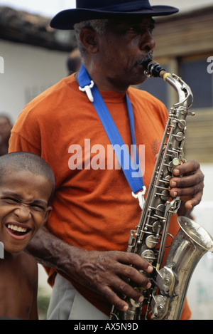 Itaparica Island, Bahia State, Brazil. Man playing a saxophone in a street procession. Stock Photo