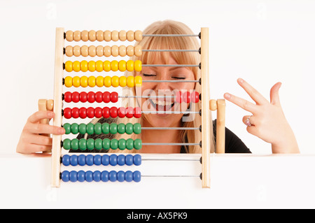 Young woman holding abacus Stock Photo