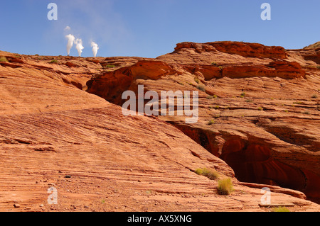 Entrance to and exit from Upper Antelope Canyon and Slot Canyon with the three smokestacks from the Navajo Generating Station i Stock Photo