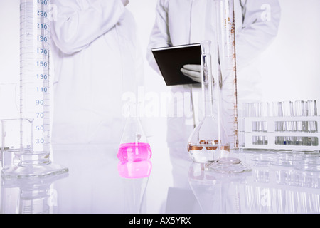 Chemist conducting an experiment in a lab Stock Photo