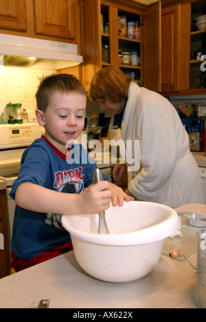 grandmother and grandson baking together in kitchen Stock Photo
