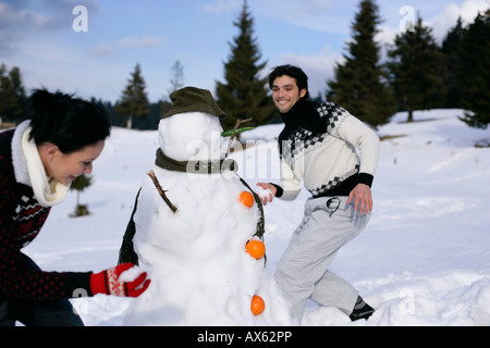 Young couple having snowball fight Stock Photo