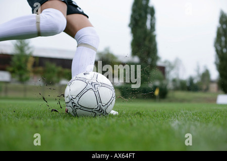 Soccer player kicking ball Stock Photo