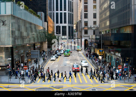 People Walking at a Crosswalk and Street View in Central Hong Kong Stock Photo