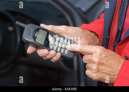 Close up of womans hands dialing on old Nokia mobile phone UK Stock Photo