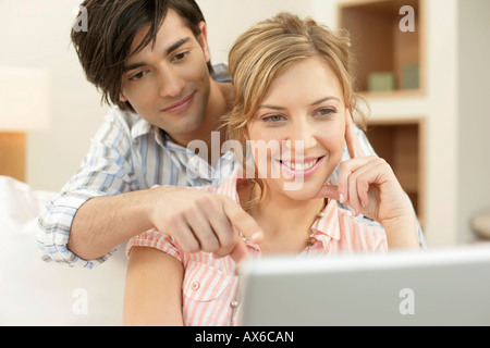 Young couple using a laptop Stock Photo