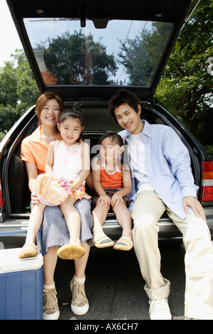 A family at the back of the van Stock Photo