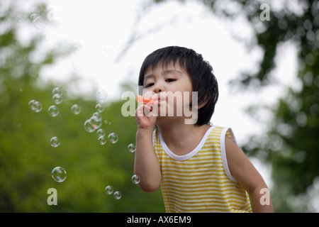 A boy blowing bubbles Stock Photo