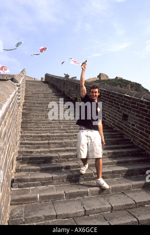 Tourist teenager flies kite at the great Wall of China having fun in Jinshanling Great Wall China Stock Photo