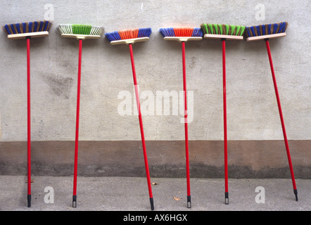 Brooms leaning against wall Stock Photo