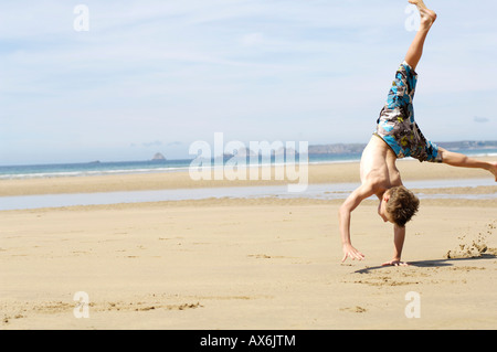 Boy doing a cartwheel Stock Photo: 11365424 - Alamy