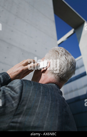 Mature businessman using mobile phone Stock Photo