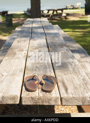 Sandals on a picnic bench Stock Photo