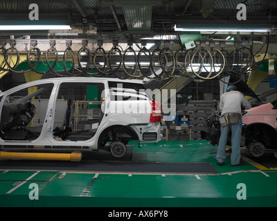 Factory workers producing the hybrid Toyota Prius cars work on the assembly line at the Toyota City Stock Photo