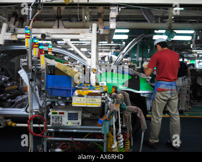 Factory workers producing the hybrid Toyota Prius cars work on the assembly line at the Toyota City Stock Photo