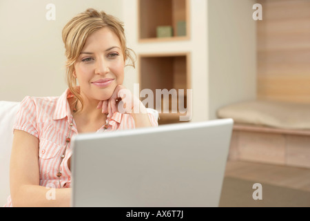 Young woman using a laptop Stock Photo
