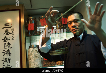 Chinese herbal medicines are weighed by a local herbal healer renowned in Hong Kong Stock Photo