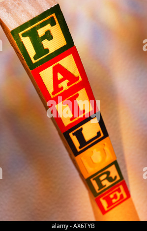 STACK OF WOODEN TOY BUILDING BLOCKS SPELLING THE WORD FAILURE Stock Photo