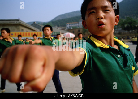 A young Chinese boy practices kung fu at the Ta Gou kung fu school in Shaolin Stock Photo