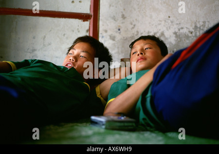 Chinese children at rest on their bed at the Ta Gou Academy in Shaolin Ta Gou is the largest martial arts school in the world Stock Photo