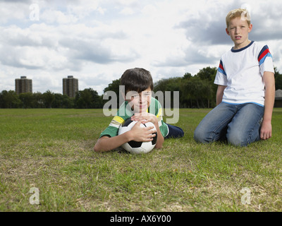 Two boys with a football in the park
