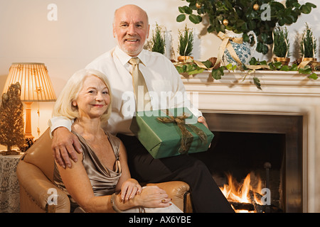 Elderly couple exchanging gifts Stock Photo