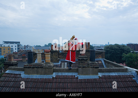 Santa claus standing on a roof Stock Photo