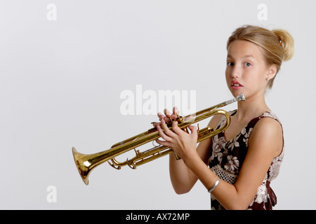 Stock Photograph of a young girl playing the trumpet Stock Photo