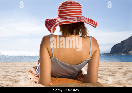 Woman lying on beach, rear view Stock Photo
