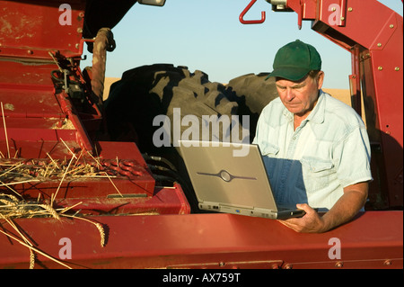 Farmer working on laptop computer. Stock Photo