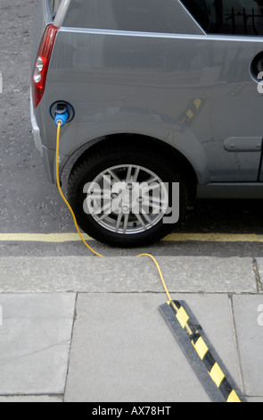 Electric car plugged in for recharging on street, City of Westminster, London SW1, Engand Stock Photo