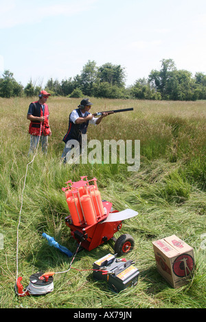 Two Clay pigeon shooters with Trap in Foreground Stock Photo