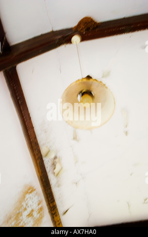 Old light fitting hanging from ceiling Stock Photo