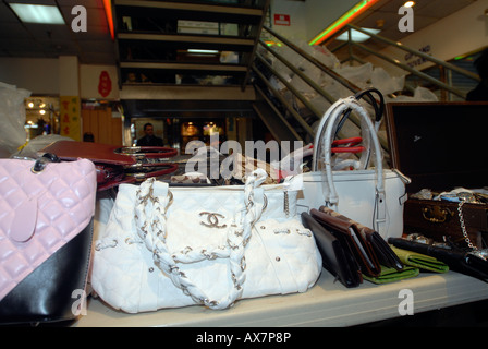 vendor illegally selling imitation name brand handbags on Canal