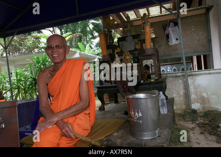 Buddhist monk, at Wat Khun Aram, Koh Samui, Thailand. Photographed out side entrance to mummified monk Louung Pordaeng. Stock Photo