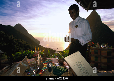 Laughing waiter standing on the terrace of Restaurant Dasheene, Ladera Resort, Soufriere, St. Lucia, Carribean Stock Photo