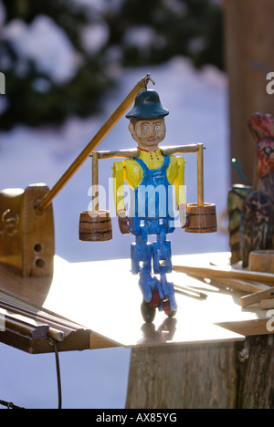 A hand carved and painted wooden figurine out on display Stock Photo