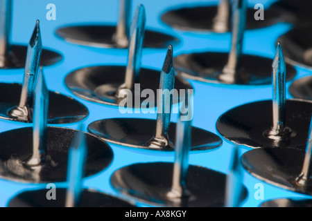 Silver Drawing Pins on a Blue Background Stock Photo