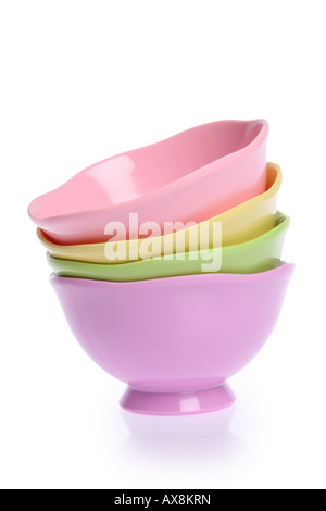 Stack of colorful bowls cut out on white background Stock Photo