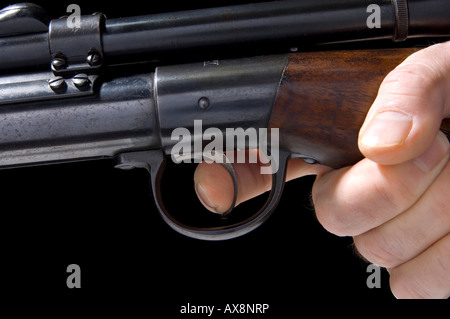 Finger on the trigger of a gun Stock Photo