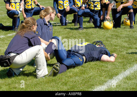 American High School Football Action sustaining injury Stock Photo