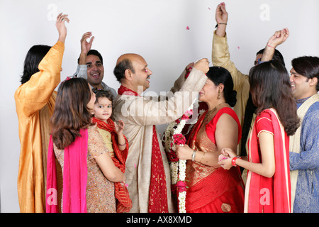 Senior couple getting married with their relatives standing aroung them Stock Photo