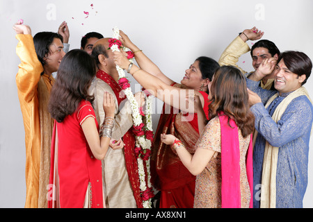 Senior couple getting married with their relatives standing aroung them Stock Photo