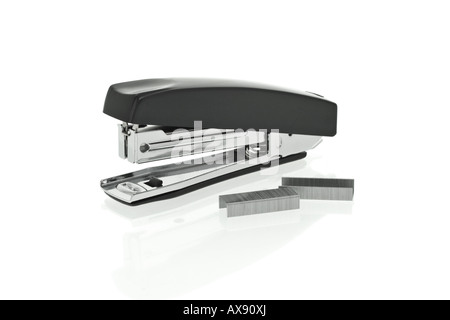 Black stapler and staples on white background Stock Photo